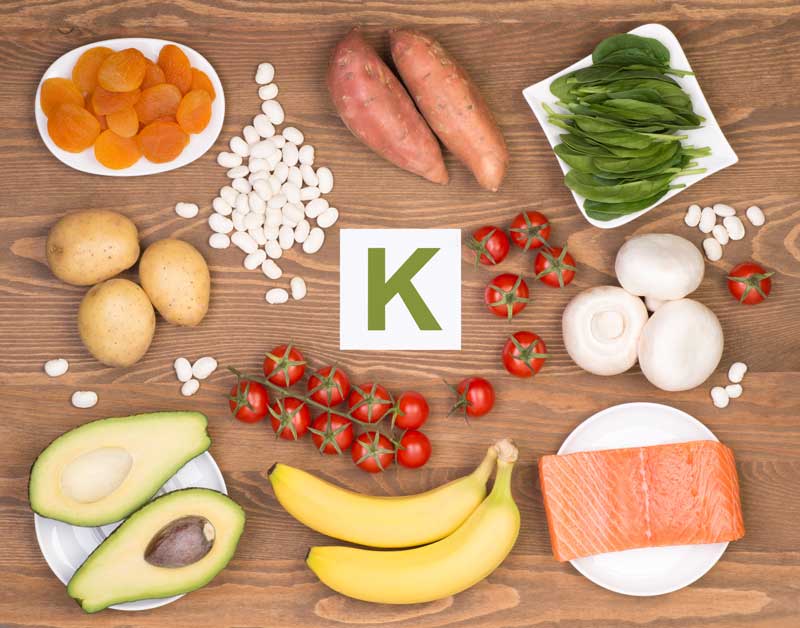 Healthy Fruits and Vegetables on table with letter K in the center