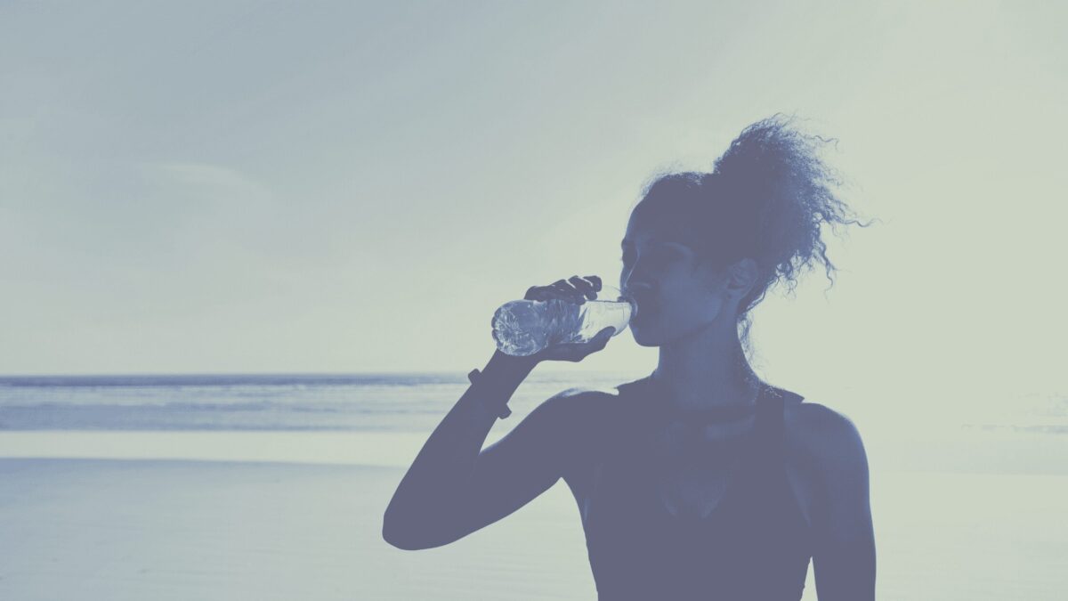 Athletic woman drinking bottle of water