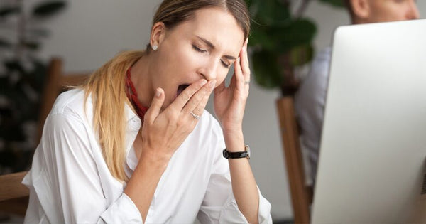 Woman yawning at desk