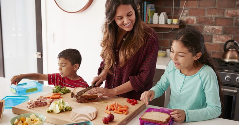 Mom preparing school lunches with kids