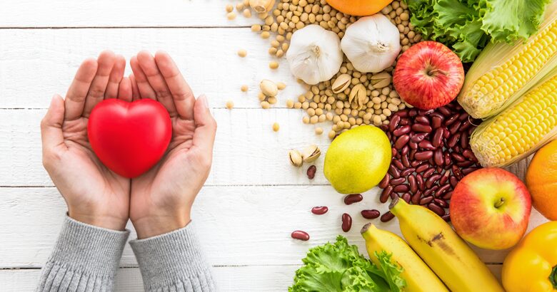 Womans hand holding heart to the left of Fiber Rich Foods