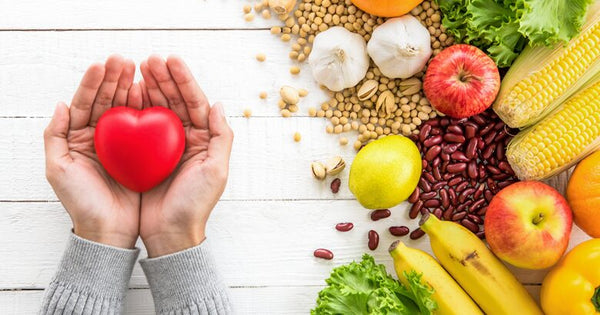 Womans hand holding heart to the left of Fiber Rich Foods